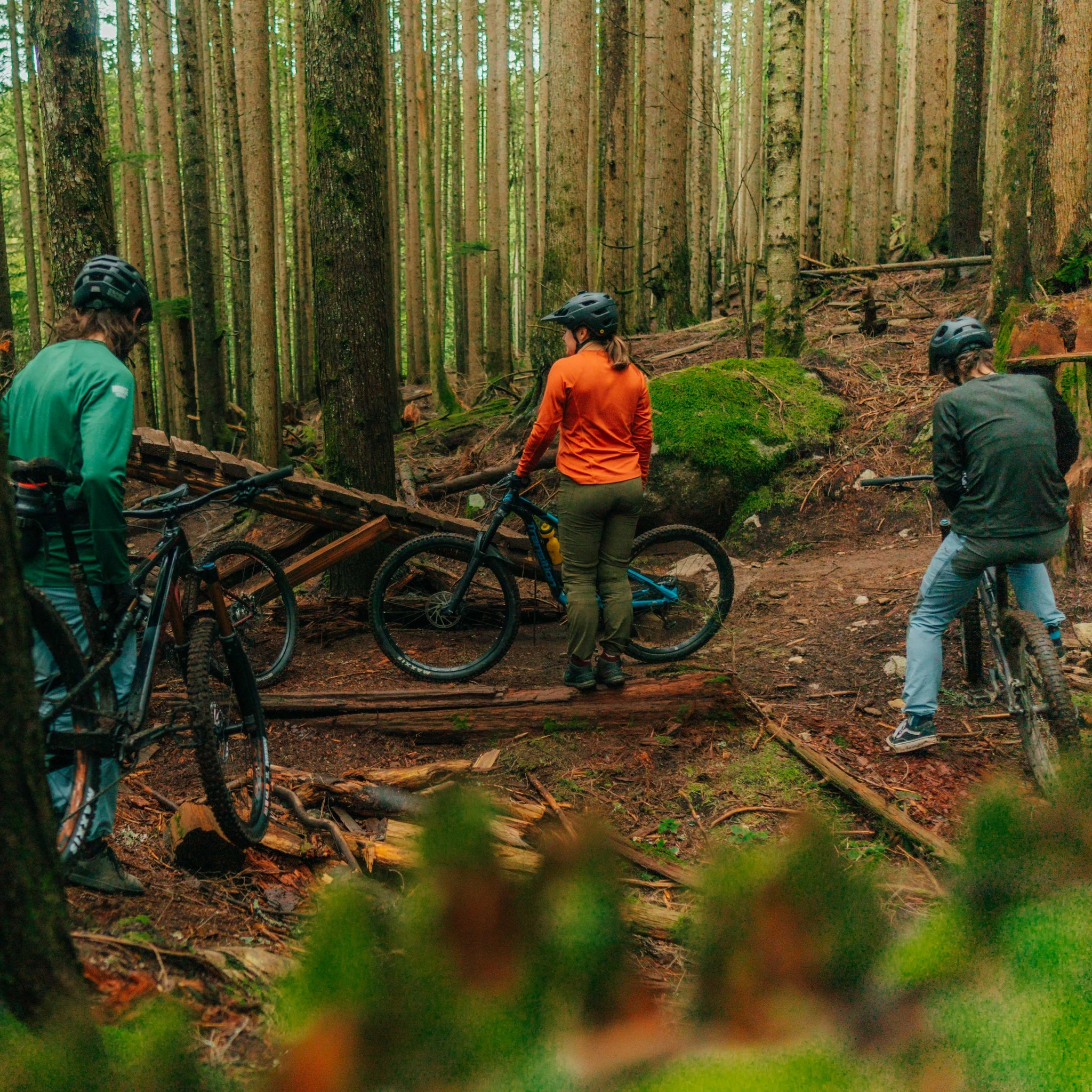 group of friends having fun while biking into the woods